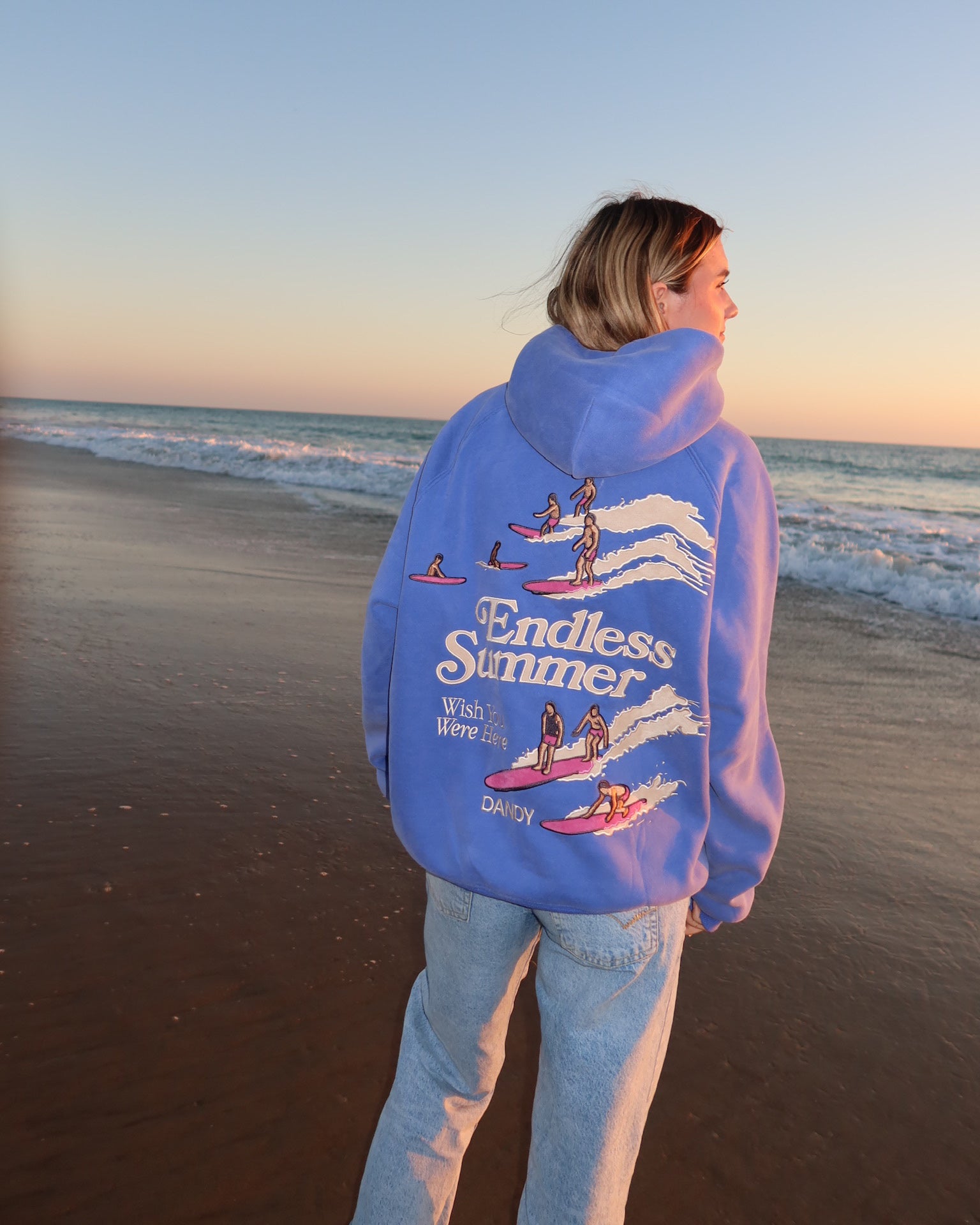 "Endless Summer" Oversized Lux Hoodie in Vintage Washed Blue on the beach at sunset