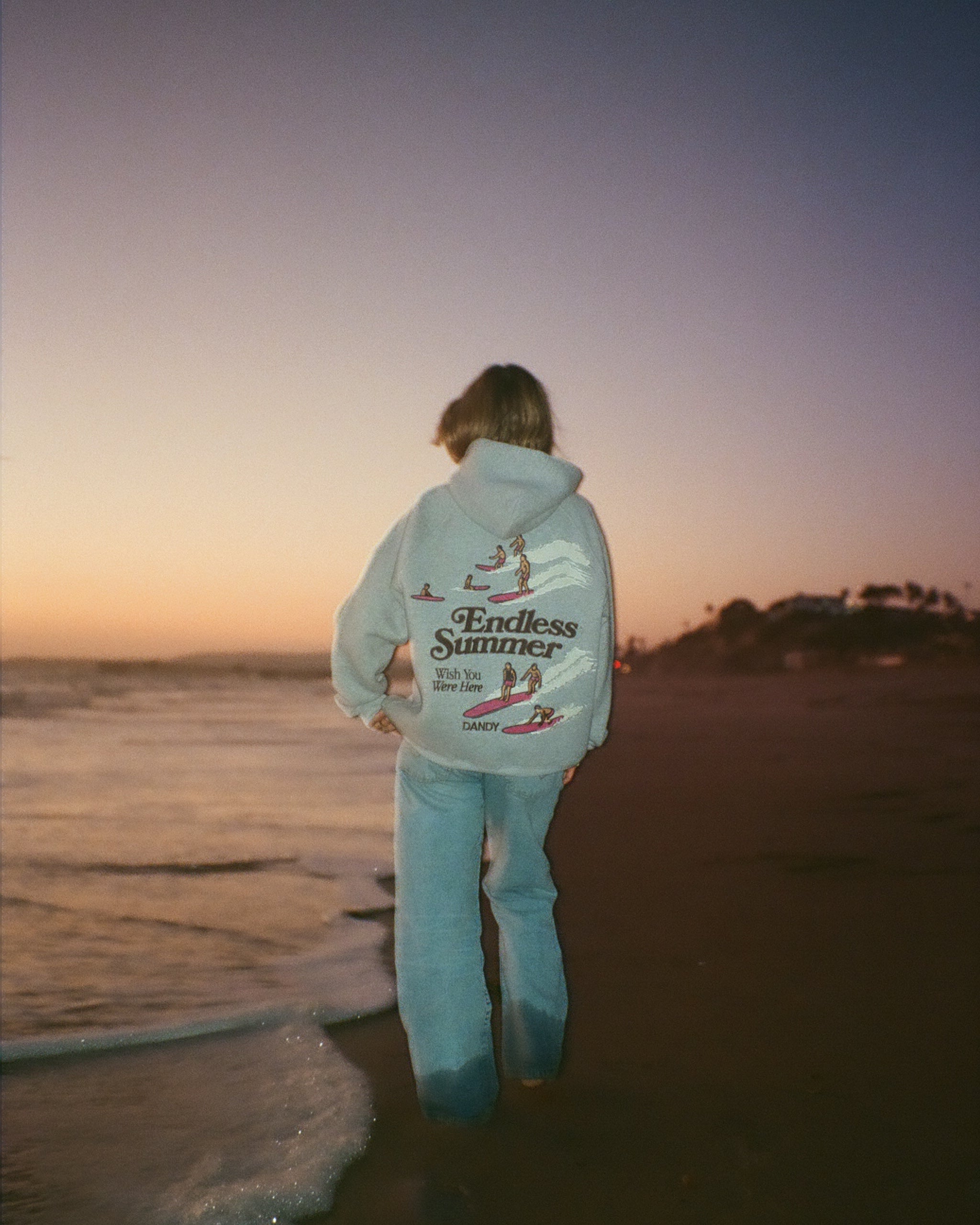 "Endless Summer" Oversized Lux Hoodie in Dark Heather on the beach at sunset