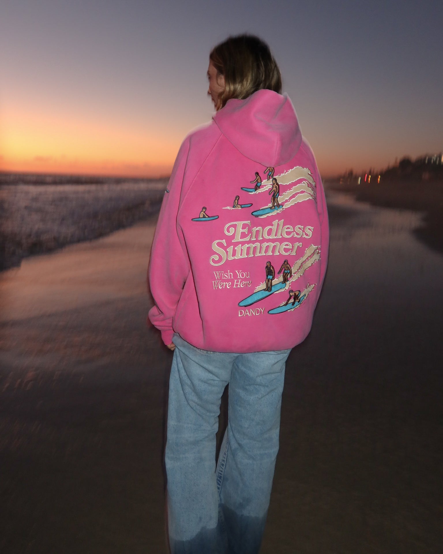 "Endless Summer" Oversized Lux Hoodie in Vintage Washed Pink on a pretty beach at sunset