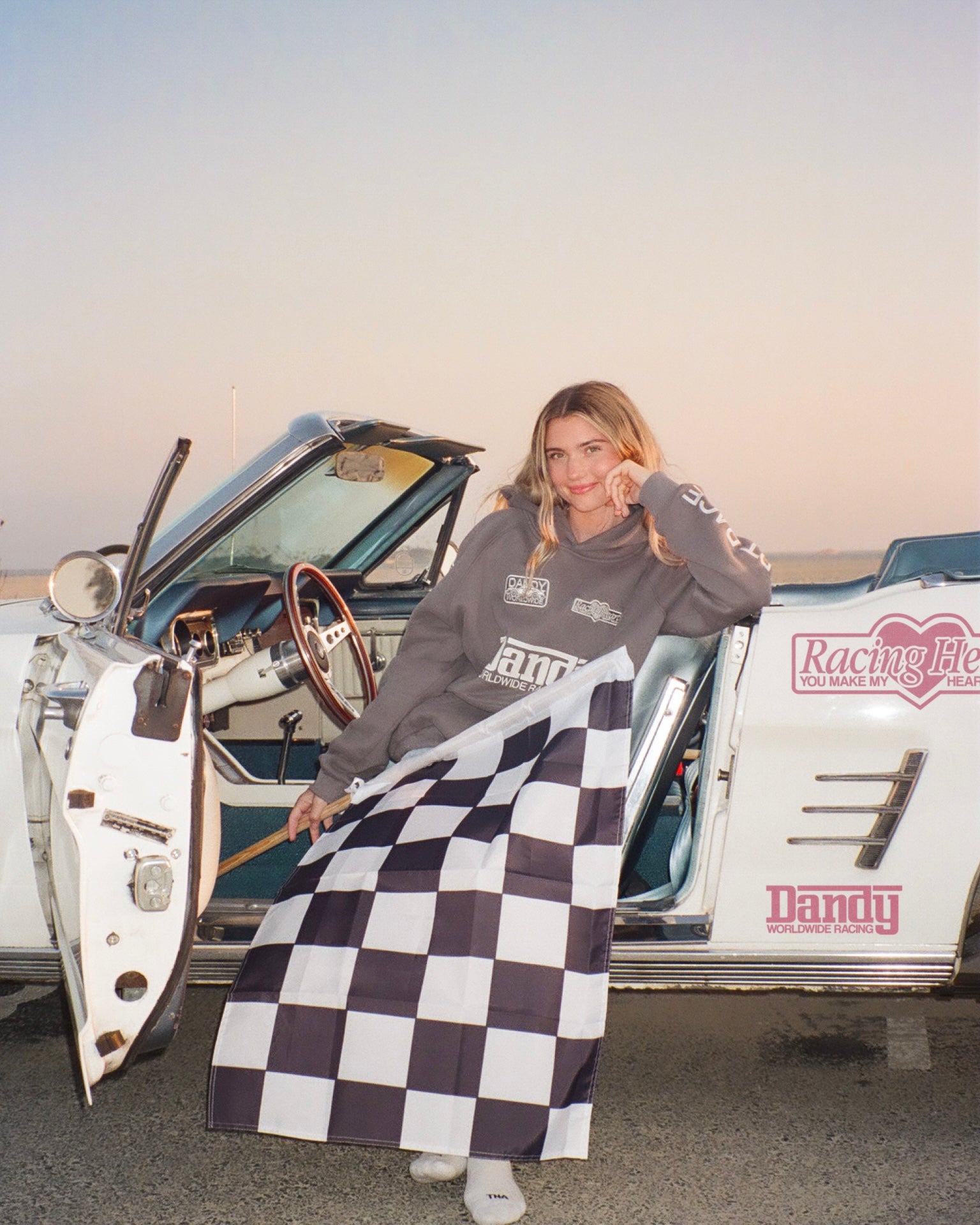 "Racing Heart" Oversized Lux Hoodie in Dark Gray. In a vintage car at sunset