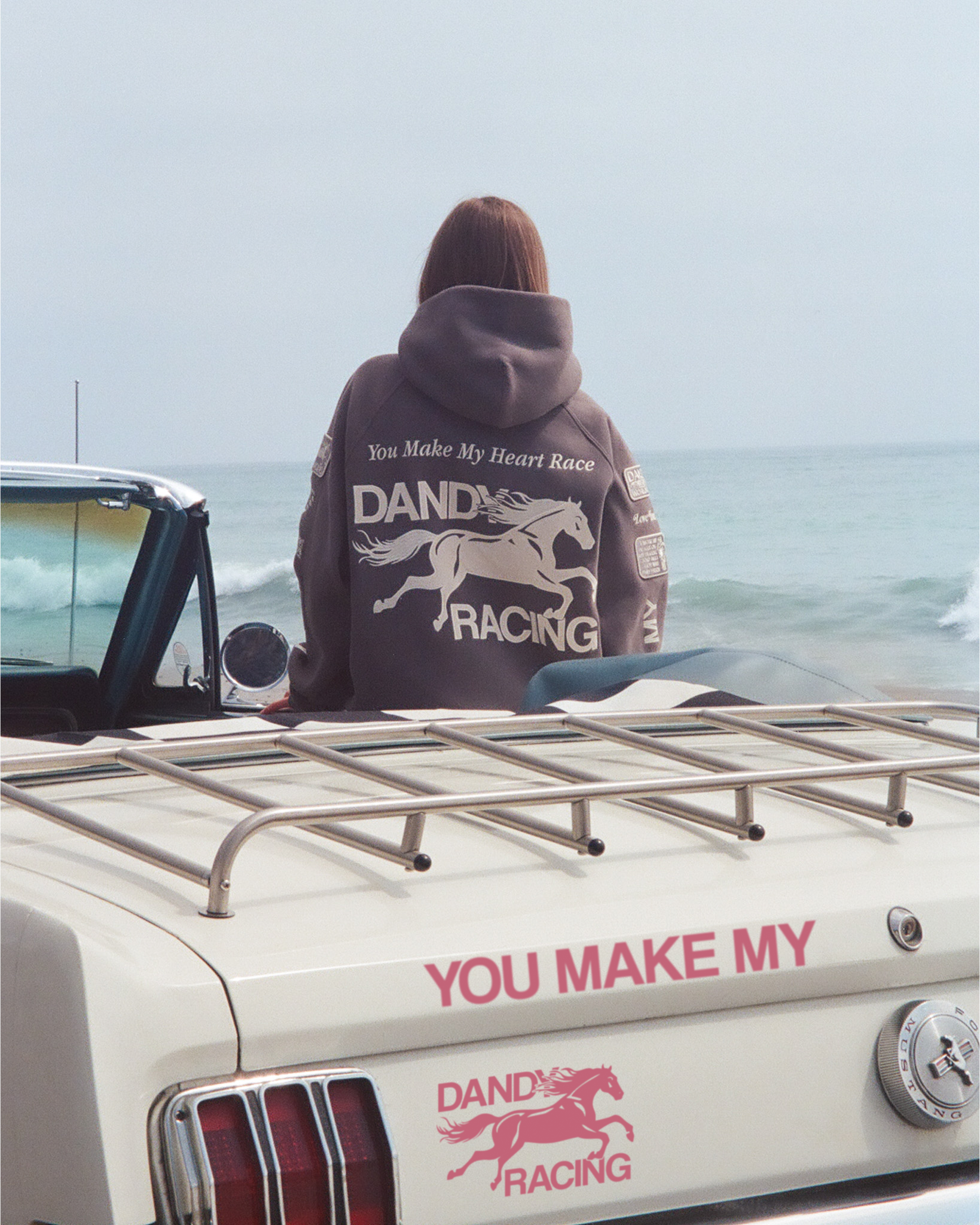 "Racing Heart" Oversized Lux Hoodie in Dark Gray leaning on the side of a vintage car