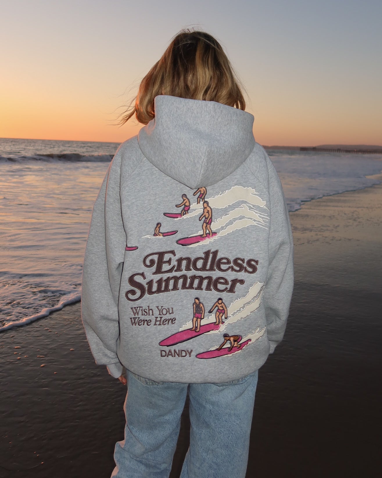 "Endless Summer" Oversized Lux Hoodie in Dark Heather on the beach at sunset