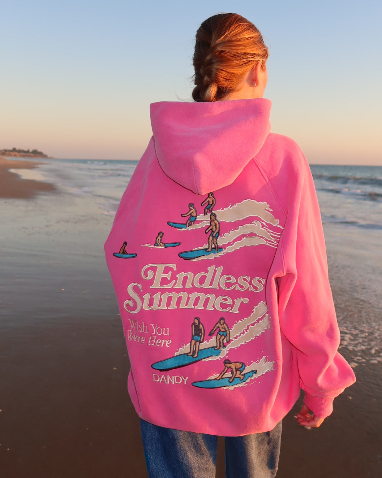 "Endless Summer" Oversized Lux Hoodie in Vintage Washed Pink on the beach at sunset