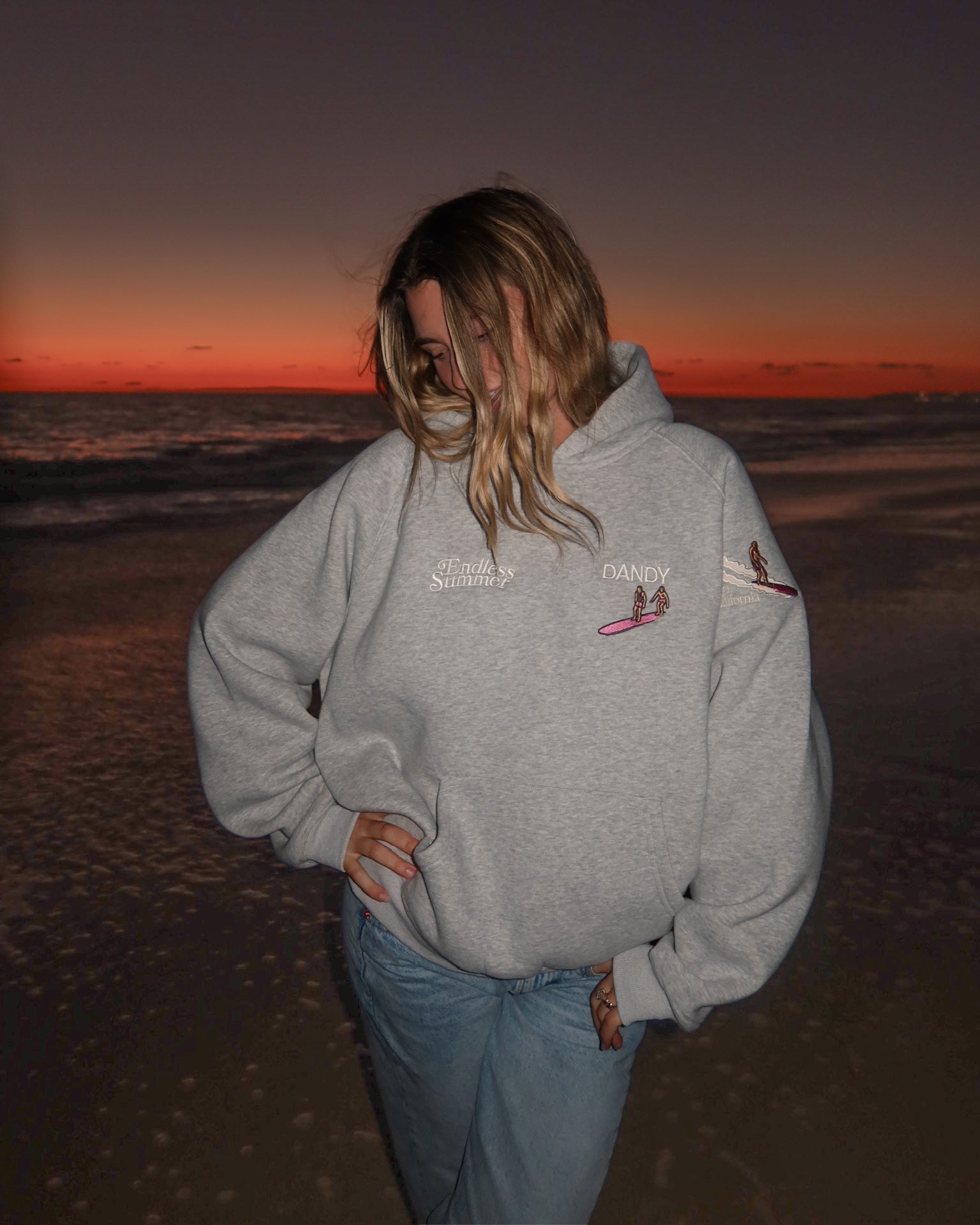 "Endless Summer" Oversized Lux Hoodie in Dark Heather showing the front of the hoodie on the beach