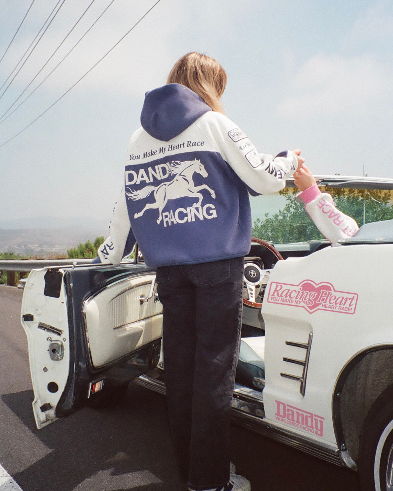 "Racing Heart" Oversized Lux Hoodie in Blue in a vintage car pulled over on the side of the road.