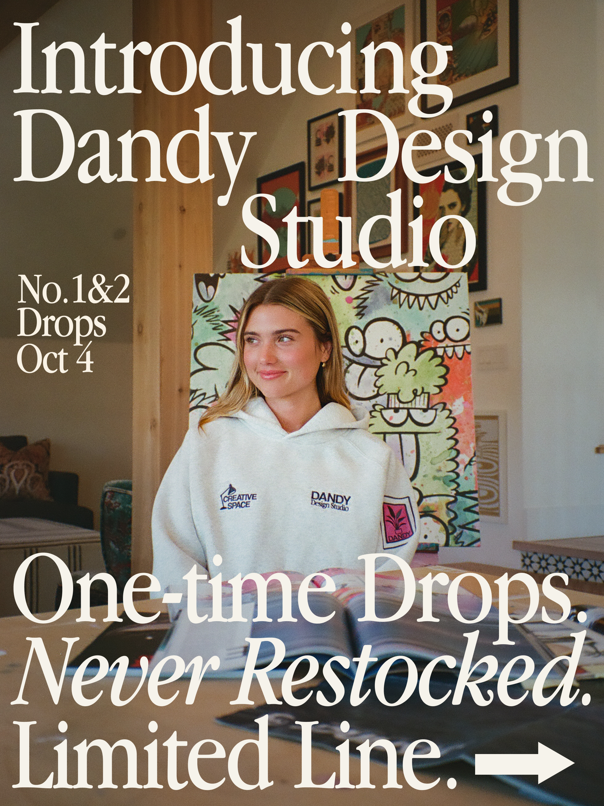 Person wearing a Dandy Design Studio sweatshirt in a room with artwork on the wall.