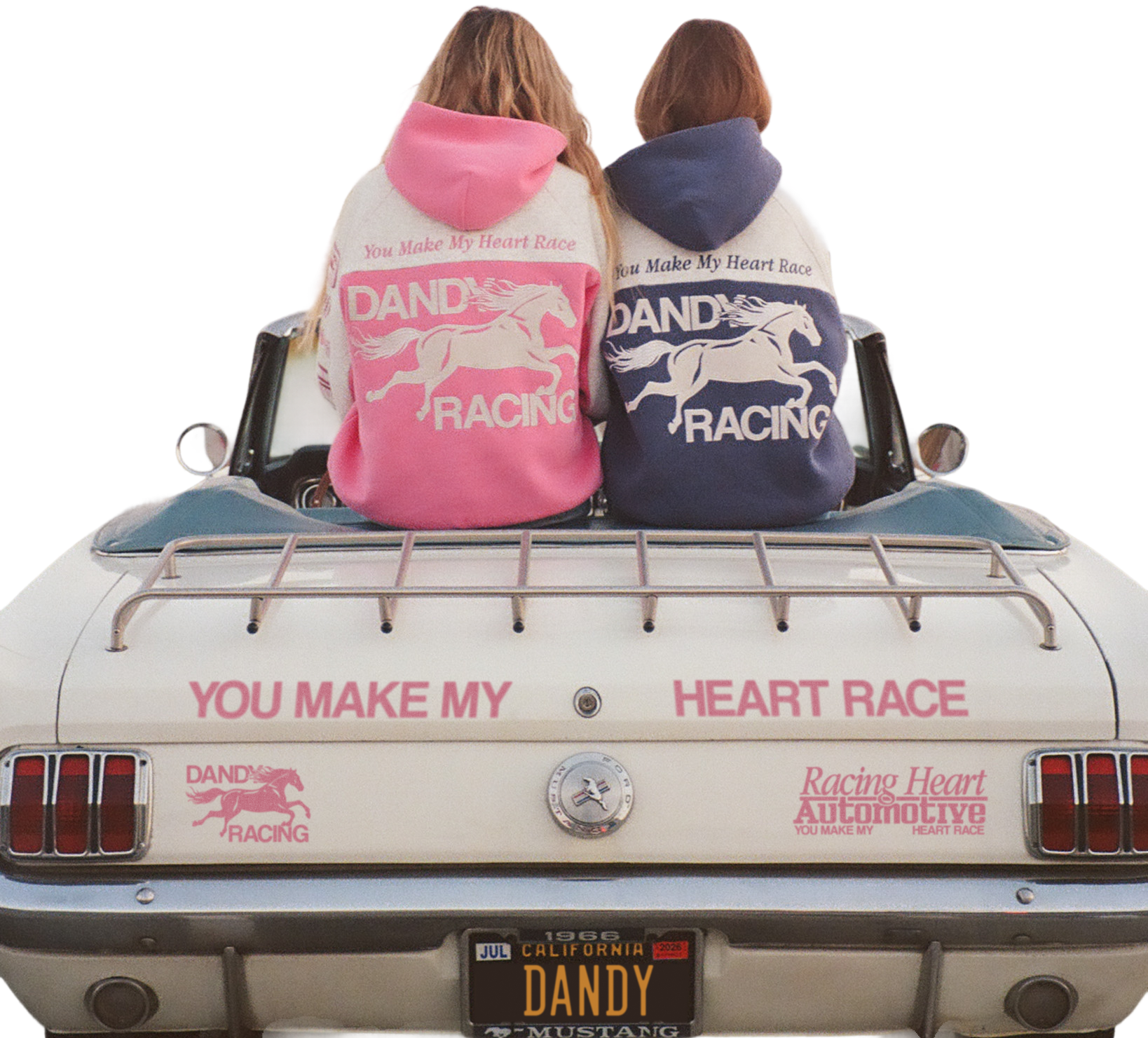 Two people wearing hoodies with racing designs sitting in a vintage car. Pink and Blue DANDY RACING hoodies.