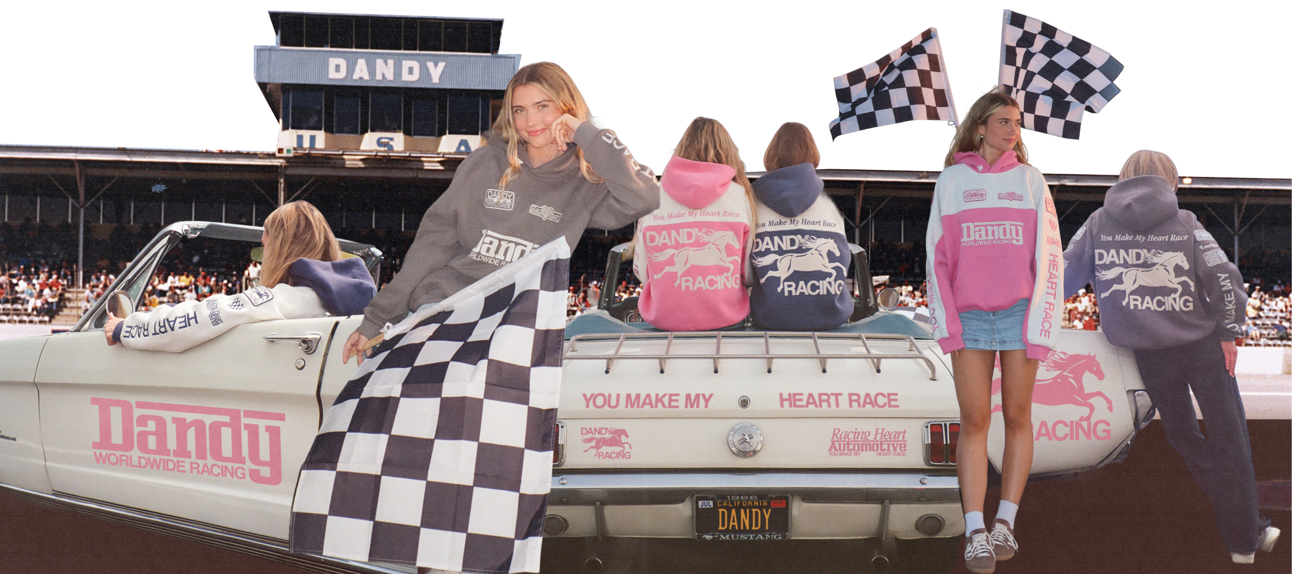 People standing on a truck with 'Dandy' branding at a race track. Pink, Blue, and Dark Grey Hoodies